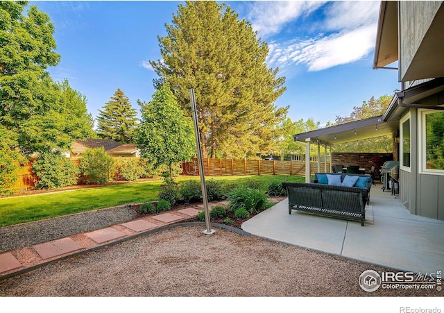 view of yard with an outdoor living space and a patio