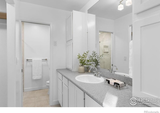 bathroom featuring tile patterned flooring, vanity, and toilet