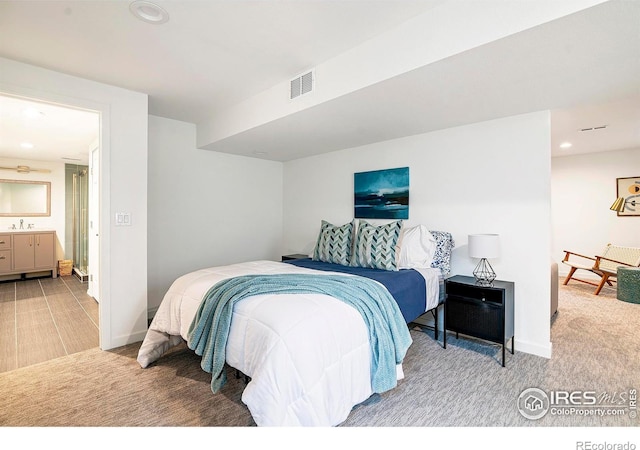 bedroom with sink and carpet flooring