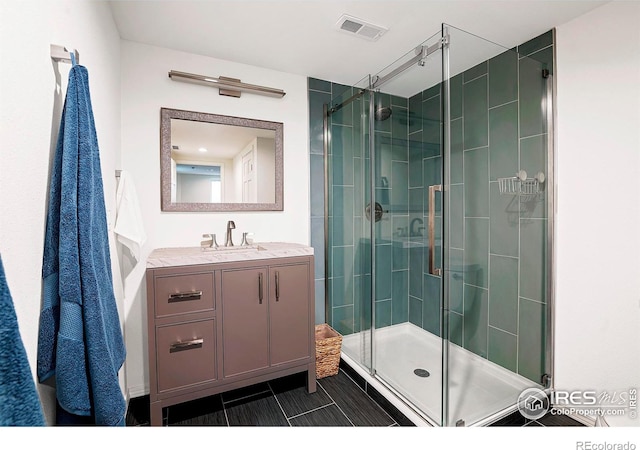 bathroom with an enclosed shower and vanity