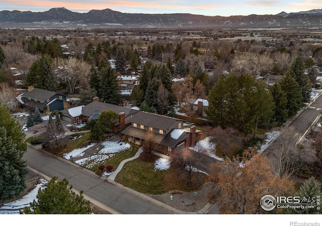 aerial view at dusk featuring a mountain view