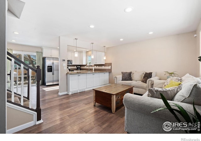 living room featuring dark hardwood / wood-style flooring and sink