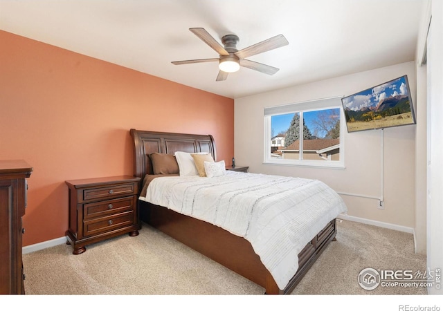 bedroom with ceiling fan and light carpet