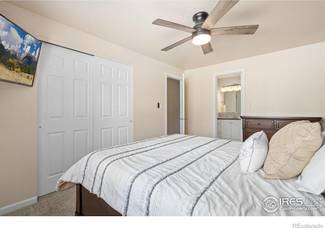 carpeted bedroom featuring ensuite bath, a closet, and ceiling fan