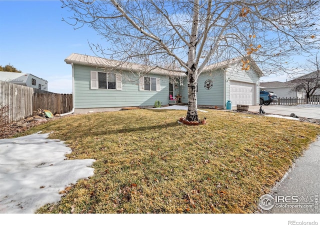 single story home with a garage and a front lawn