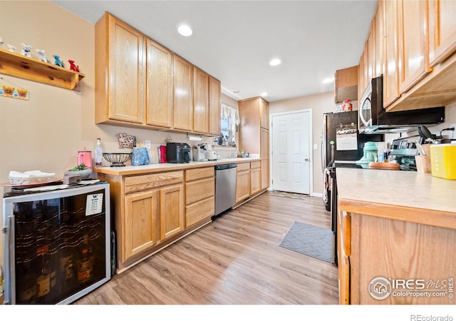 kitchen featuring wine cooler, stainless steel appliances, and light brown cabinets