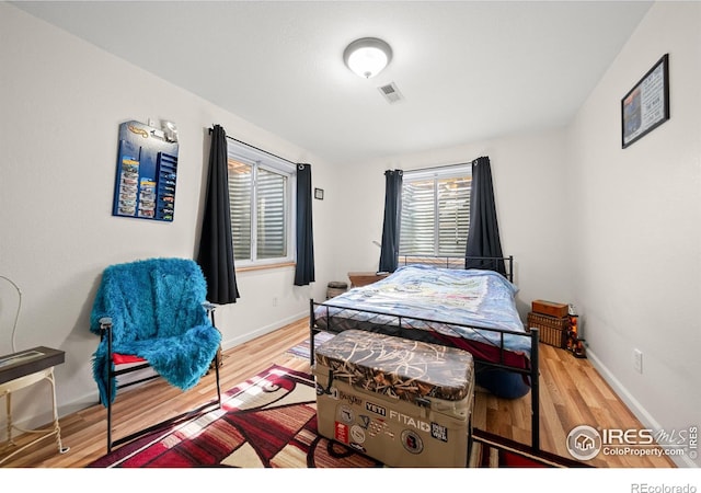 bedroom with wood-type flooring