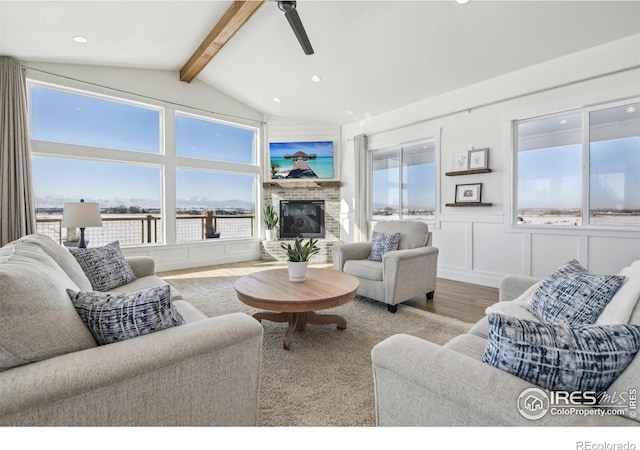 living room featuring lofted ceiling with beams and light wood-type flooring