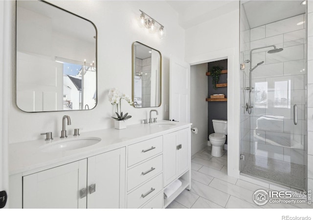 bathroom featuring vanity, toilet, and an enclosed shower