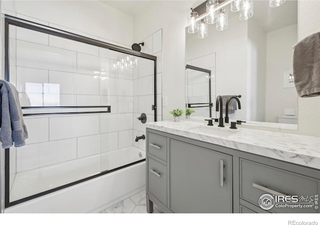 full bathroom featuring vanity, toilet, and combined bath / shower with glass door