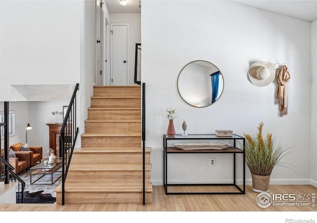 stairs featuring wood-type flooring and a textured ceiling