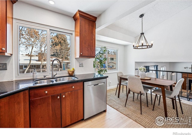 kitchen featuring sink, an inviting chandelier, light wood-type flooring, dishwasher, and pendant lighting