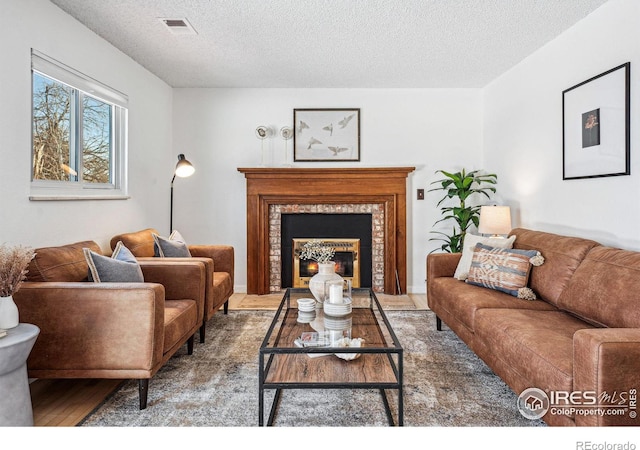 living room featuring wood-type flooring and a textured ceiling