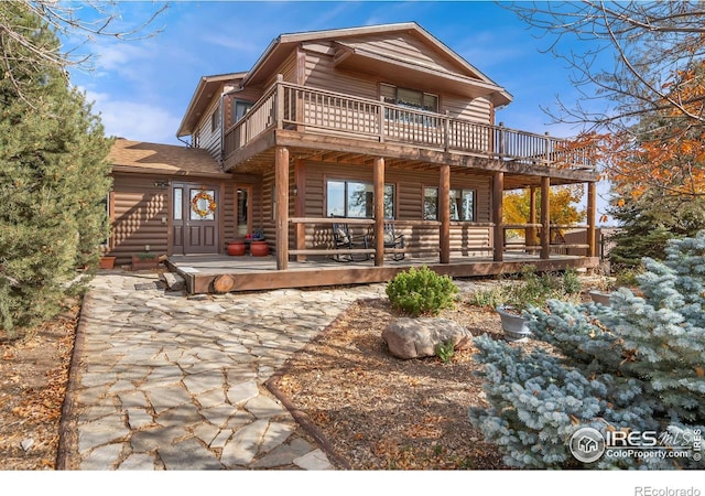 back of house with a wooden deck