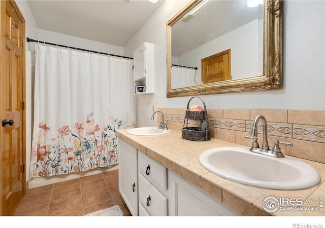 bathroom with vanity, backsplash, and tile patterned floors