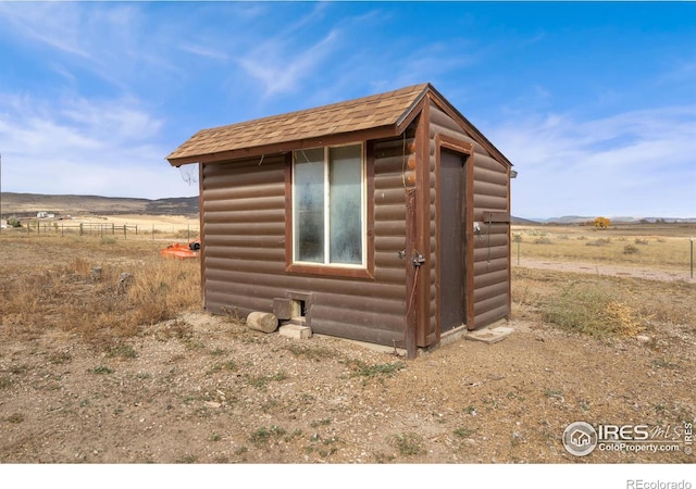 view of outbuilding with a rural view