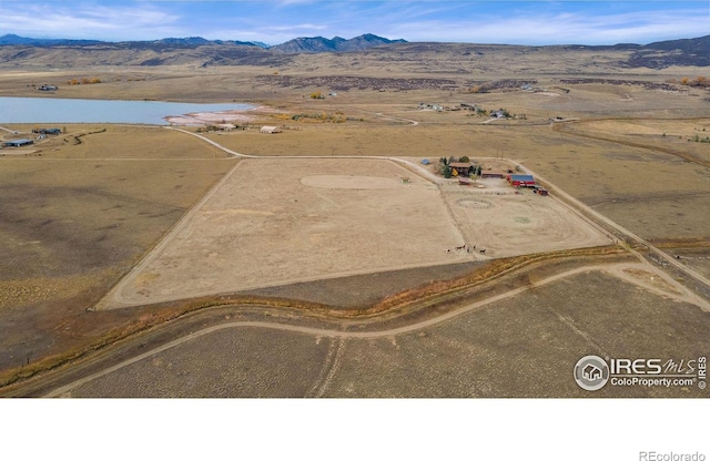 birds eye view of property featuring a water and mountain view