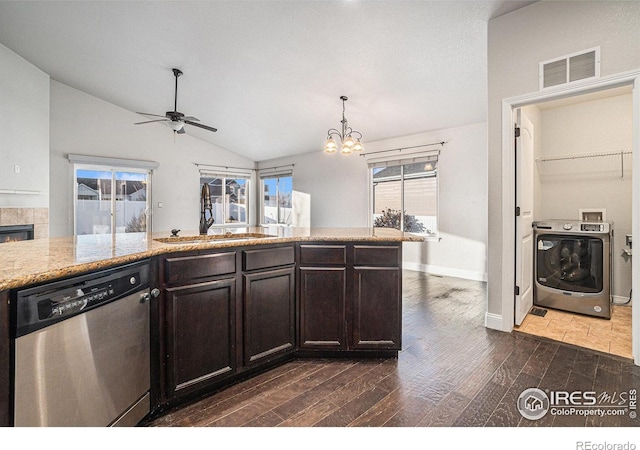 kitchen with sink, dishwasher, dark brown cabinets, dark hardwood / wood-style floors, and washer / dryer