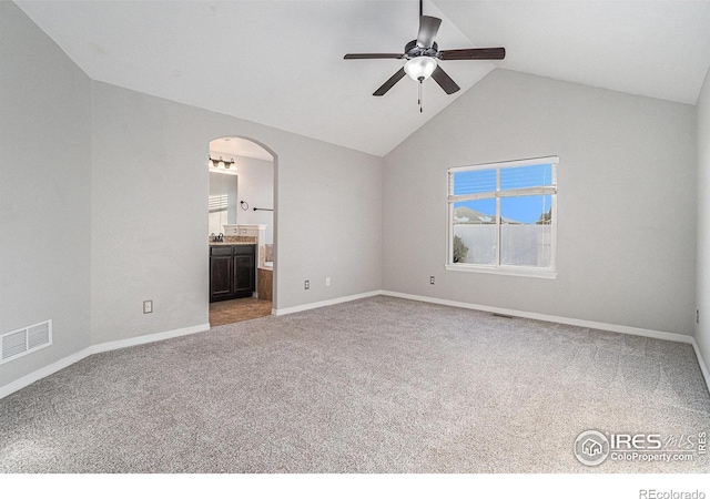 carpeted spare room with lofted ceiling and ceiling fan