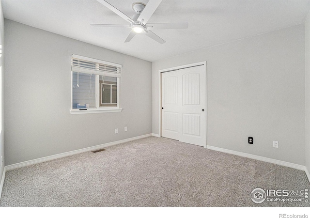 spare room featuring carpet floors and ceiling fan