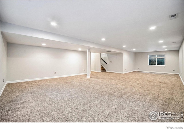 basement featuring light carpet