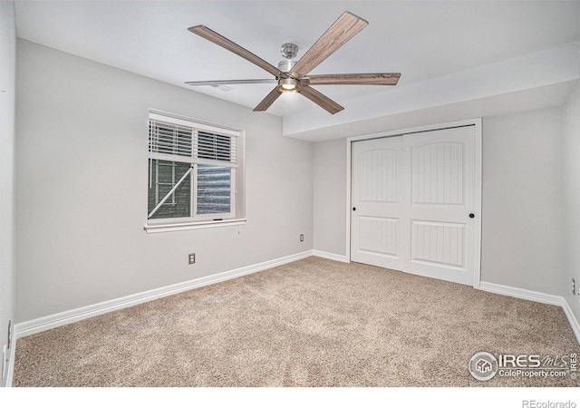 unfurnished bedroom featuring a closet, ceiling fan, and carpet flooring