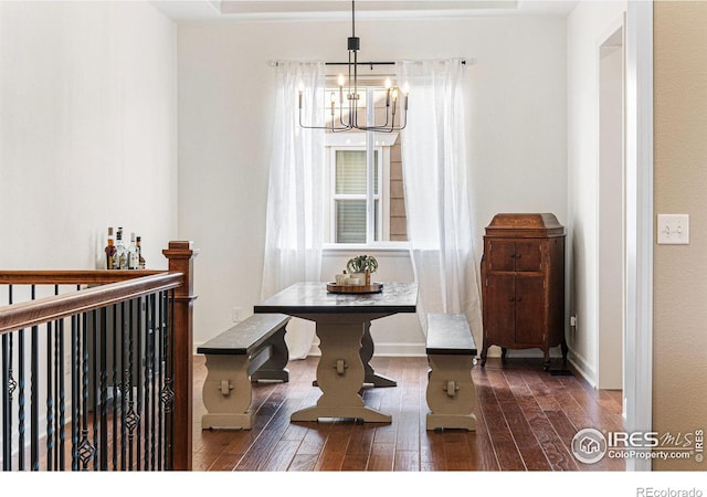 dining room featuring dark hardwood / wood-style flooring and a chandelier