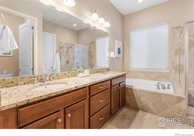 full bathroom featuring tile patterned flooring, plus walk in shower, vanity, and toilet