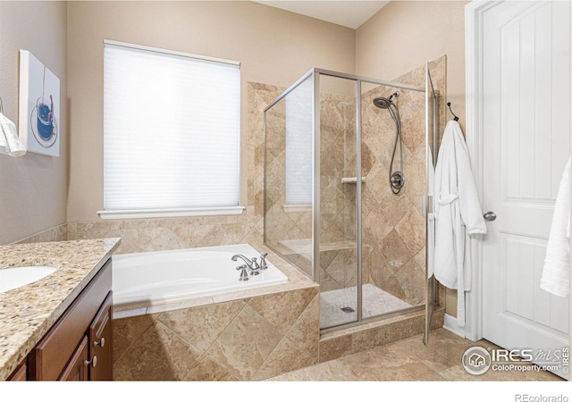 bathroom with vanity and separate shower and tub