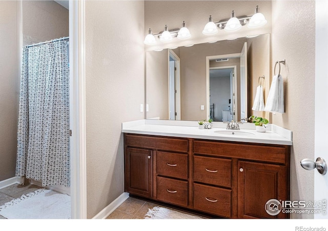 bathroom with vanity, tile patterned floors, and a shower with curtain