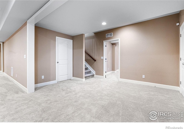 basement featuring light colored carpet