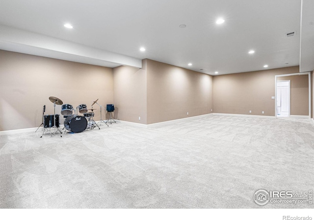 basement featuring light carpet