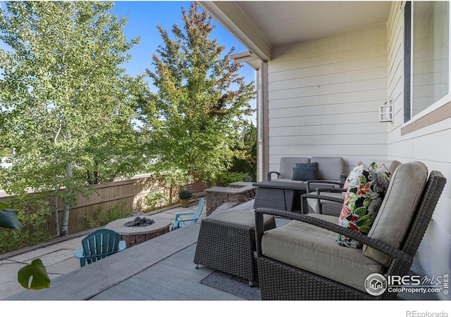 view of patio / terrace with an outdoor living space with a fire pit