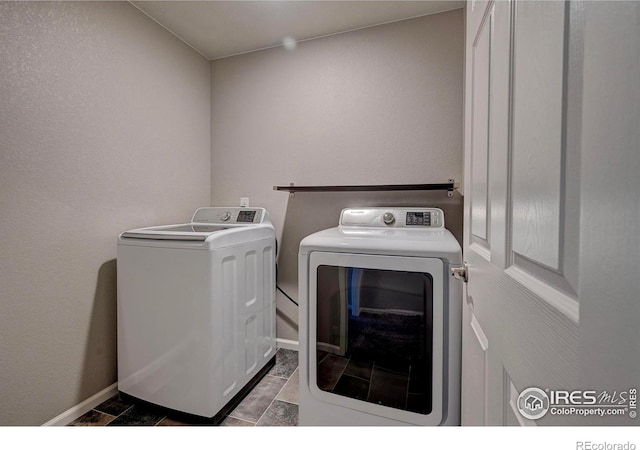 laundry room featuring washing machine and clothes dryer