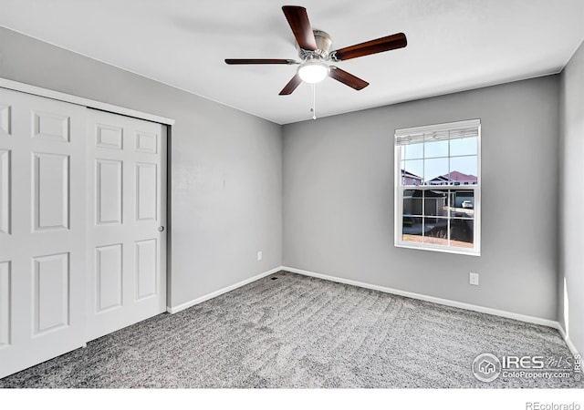 unfurnished bedroom with ceiling fan, a closet, and carpet