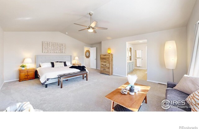 bedroom with ceiling fan, light colored carpet, ensuite bathroom, and vaulted ceiling