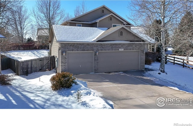 view of snowy exterior with a garage