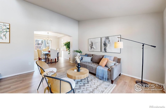 living room with wood-type flooring and a chandelier