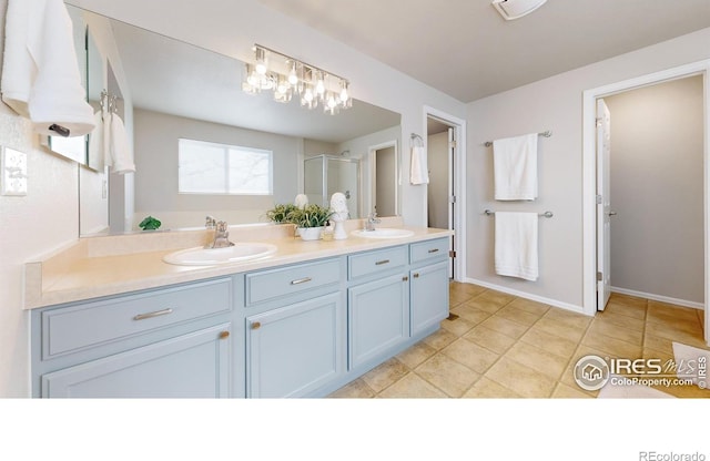 bathroom featuring tile patterned flooring, vanity, and walk in shower