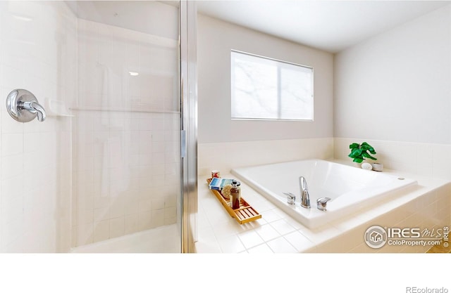 bathroom with separate shower and tub