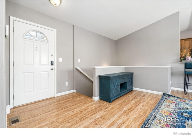 entryway featuring lofted ceiling and hardwood / wood-style floors