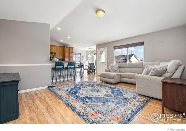 living room with hardwood / wood-style flooring and lofted ceiling