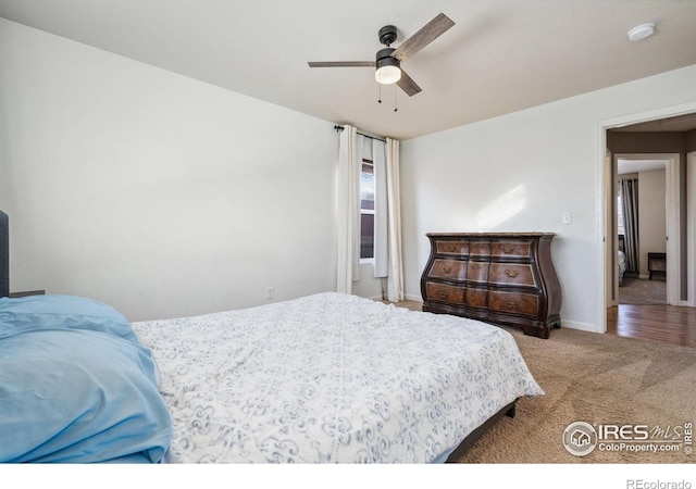 bedroom featuring ceiling fan and carpet