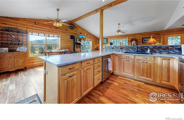 kitchen featuring kitchen peninsula, light wood-type flooring, dishwasher, and vaulted ceiling with beams