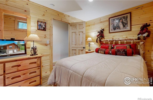 bedroom with wood walls