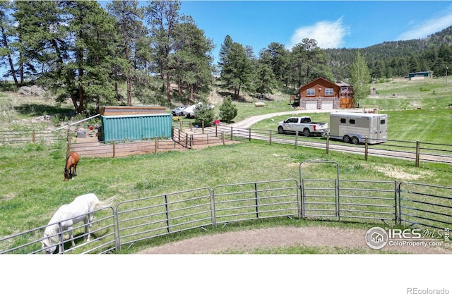 view of yard with a rural view and an outbuilding