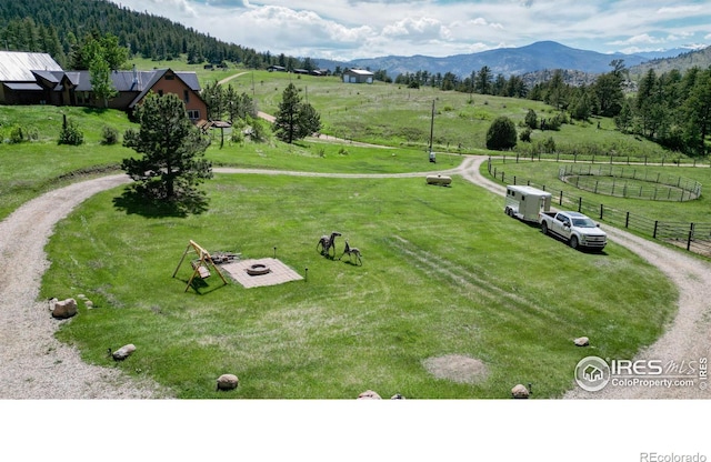 birds eye view of property with a mountain view and a rural view