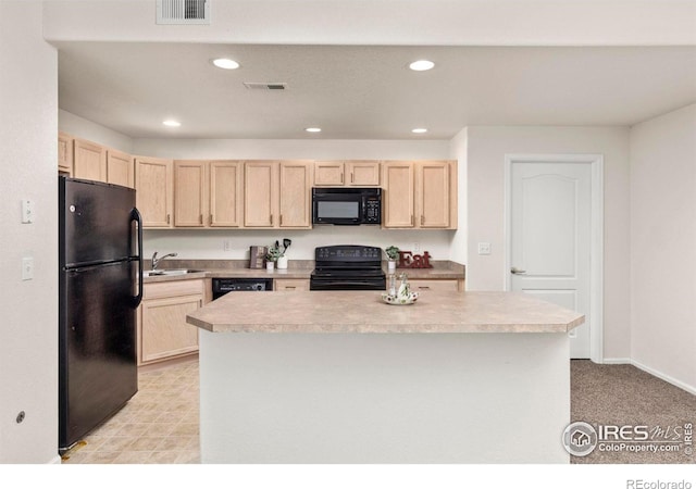 kitchen with light brown cabinetry, sink, a kitchen island, and black appliances