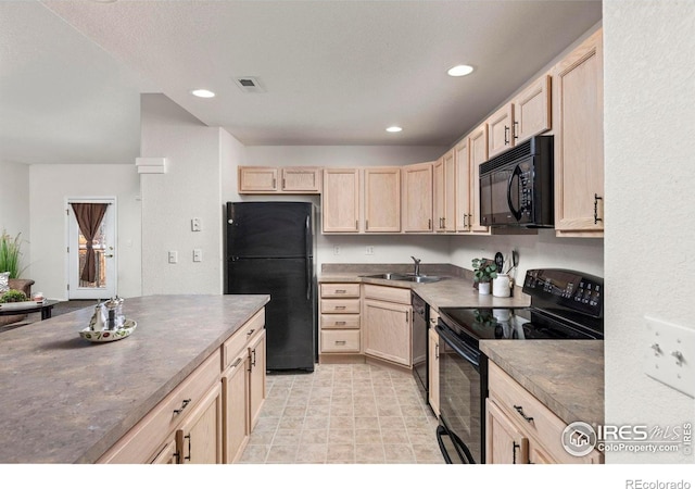 kitchen featuring sink, light brown cabinets, and black appliances