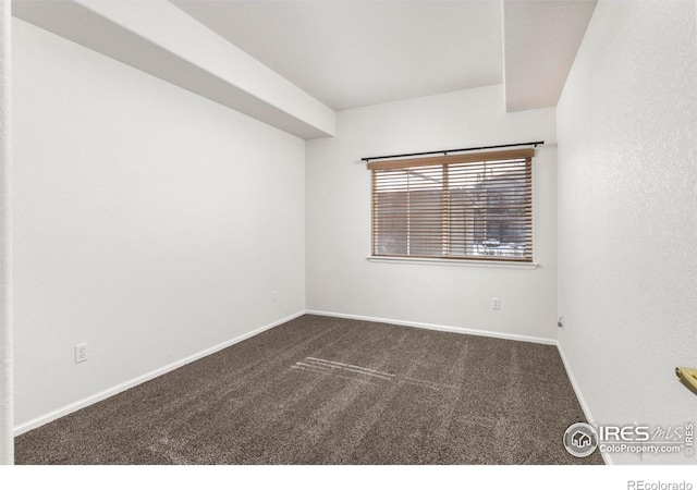 empty room featuring dark colored carpet